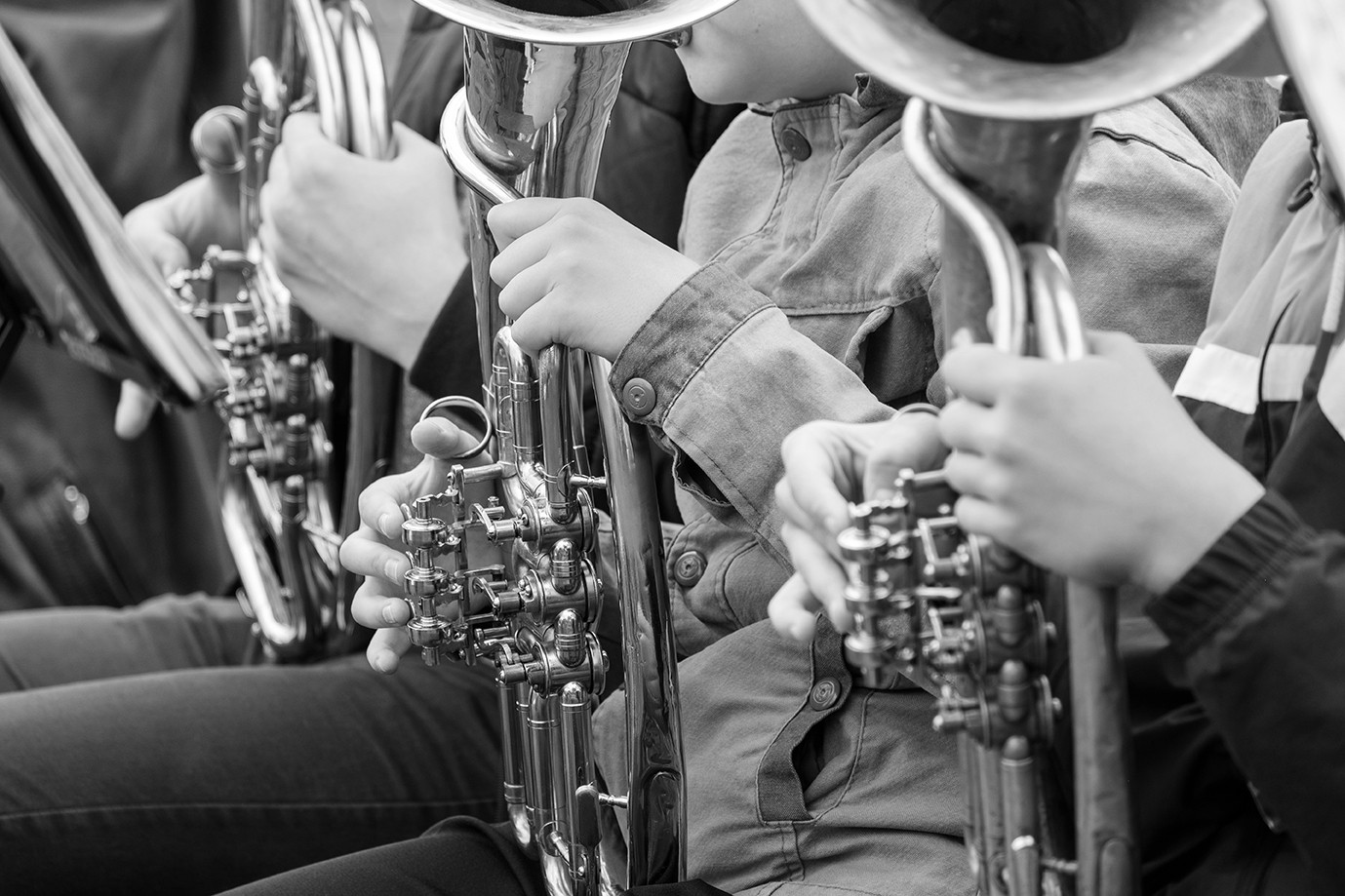 street musicians playing wind instruments outdoors in outerwear. playing for the sake of earning street musicians on the horns